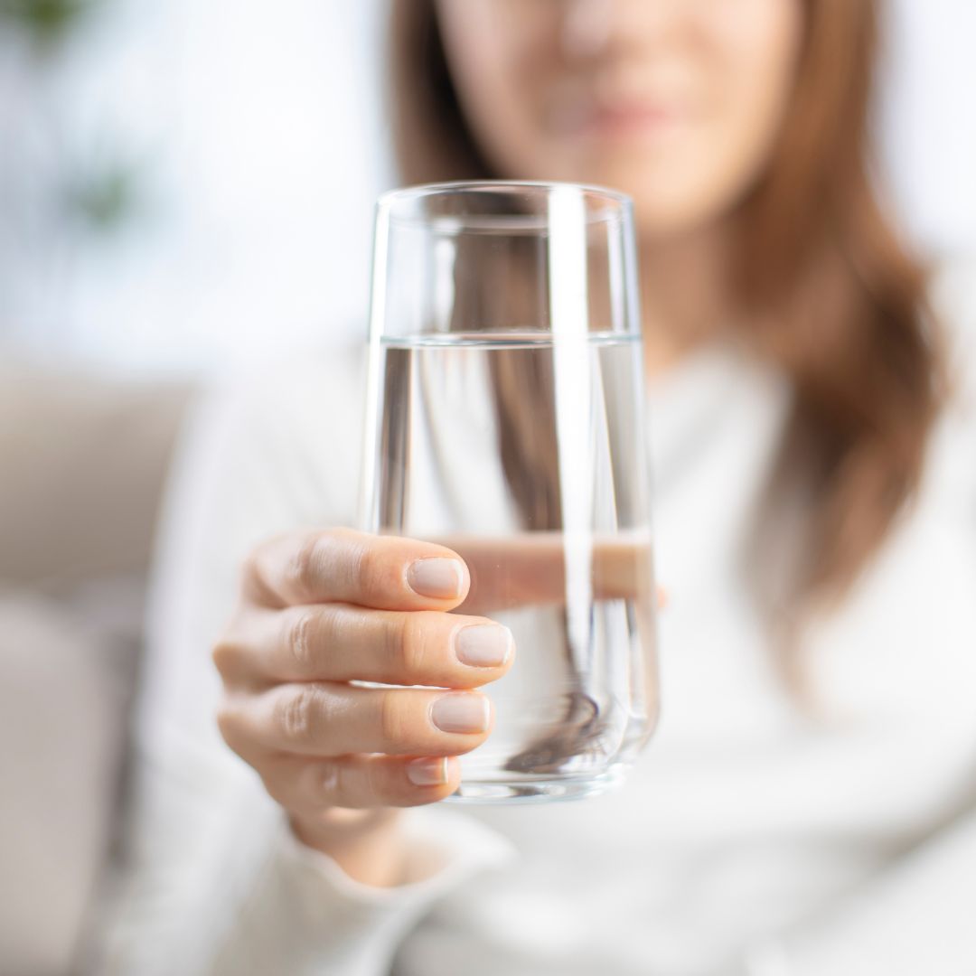 Woman holding a glass of water