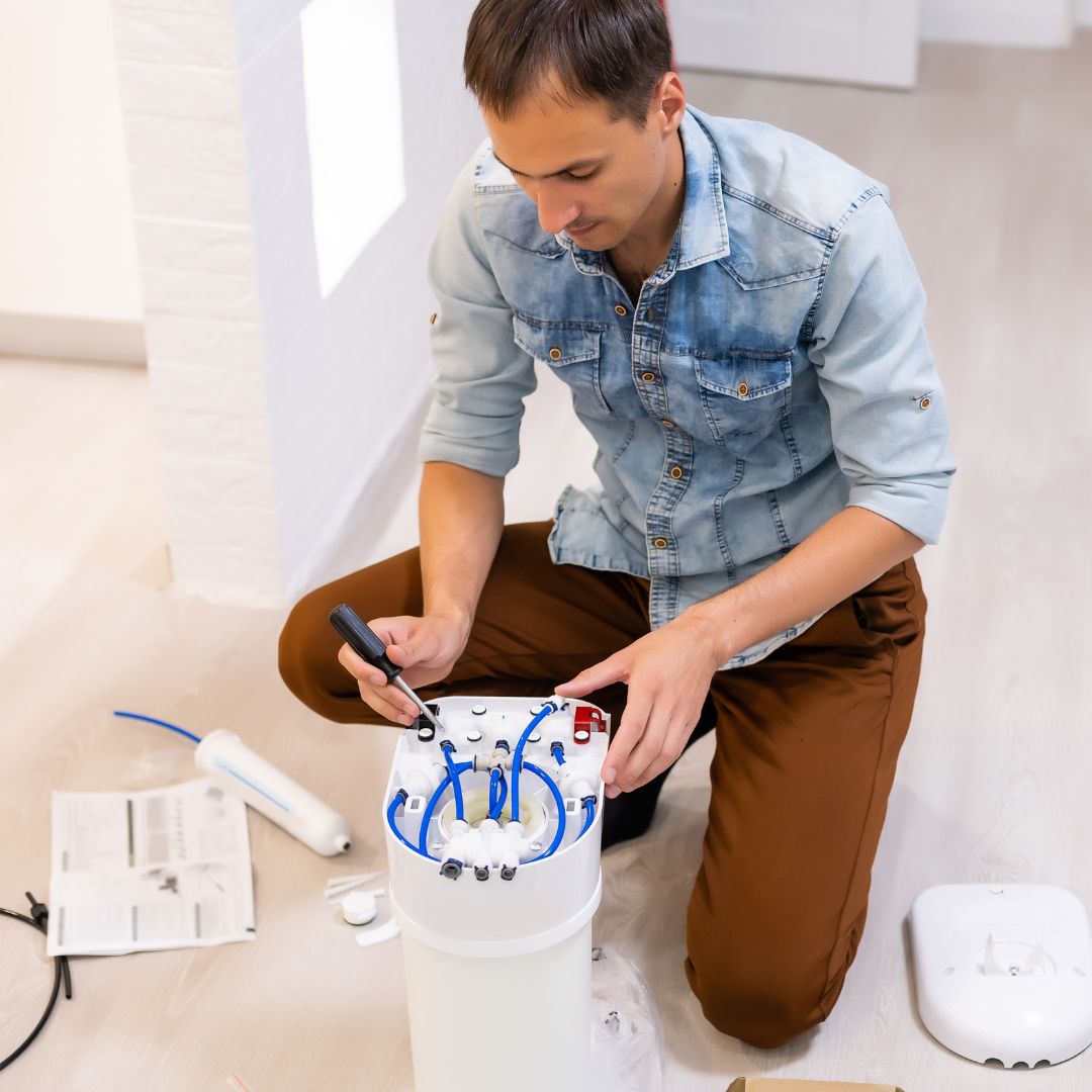 person installing water softener