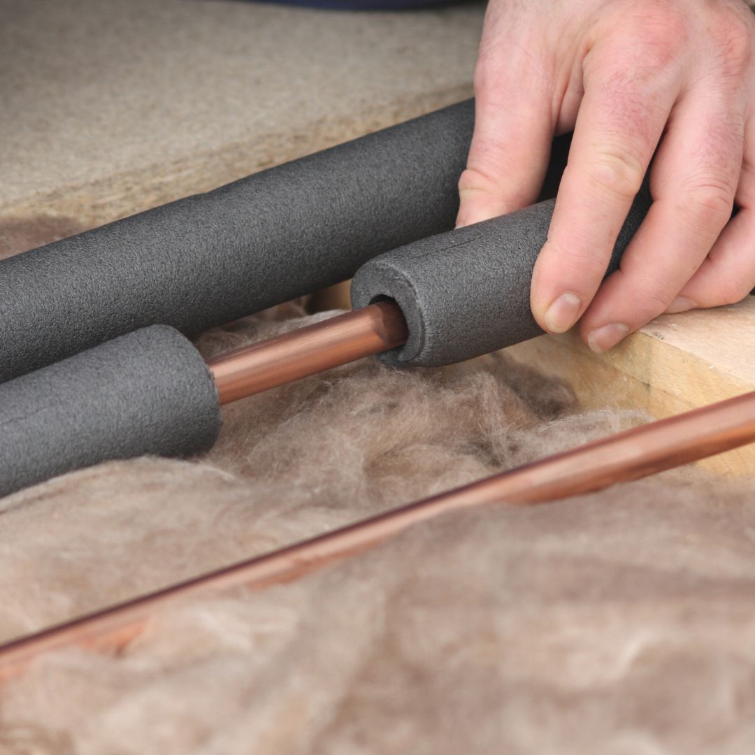 person insulating pipes