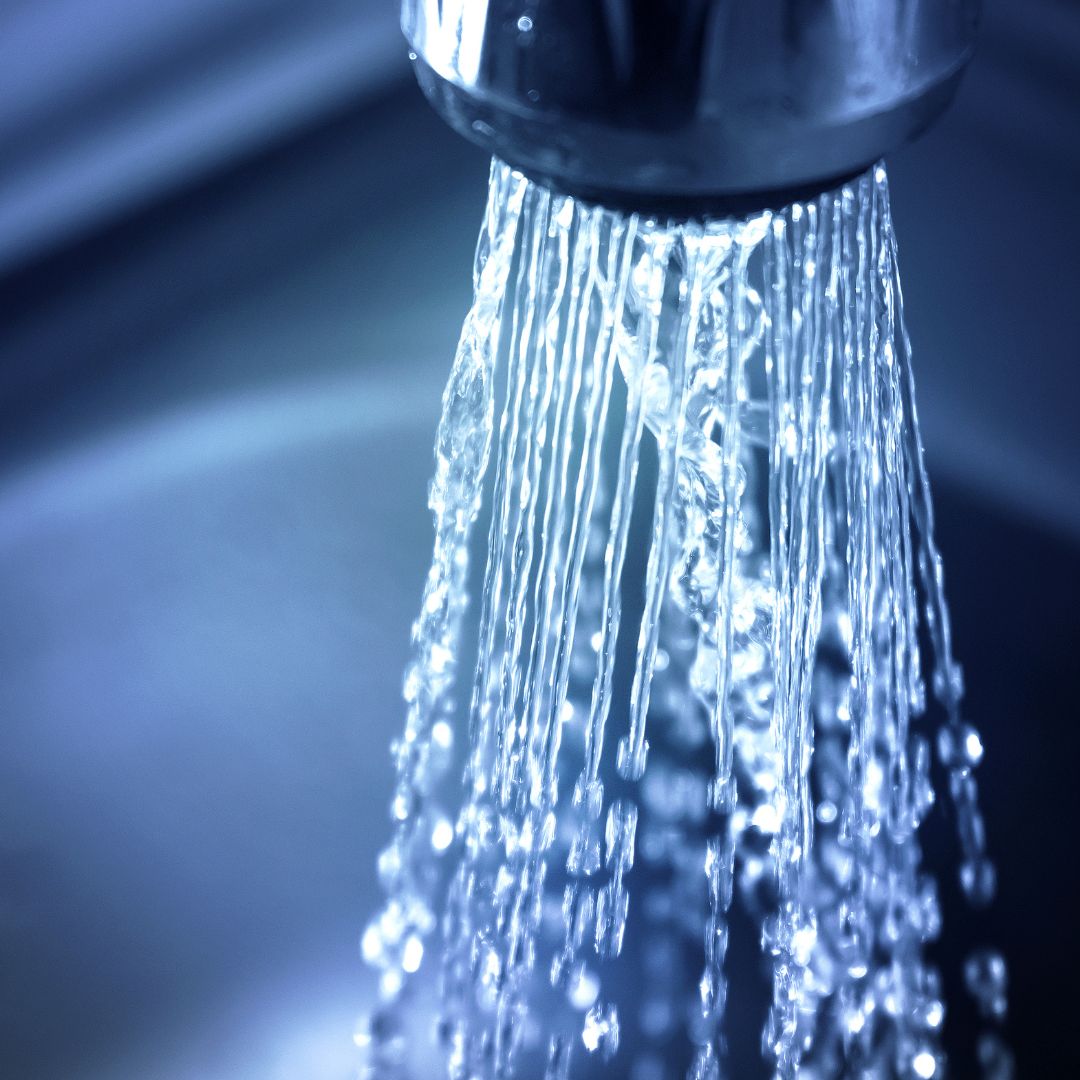 close up of water flowing out of faucet
