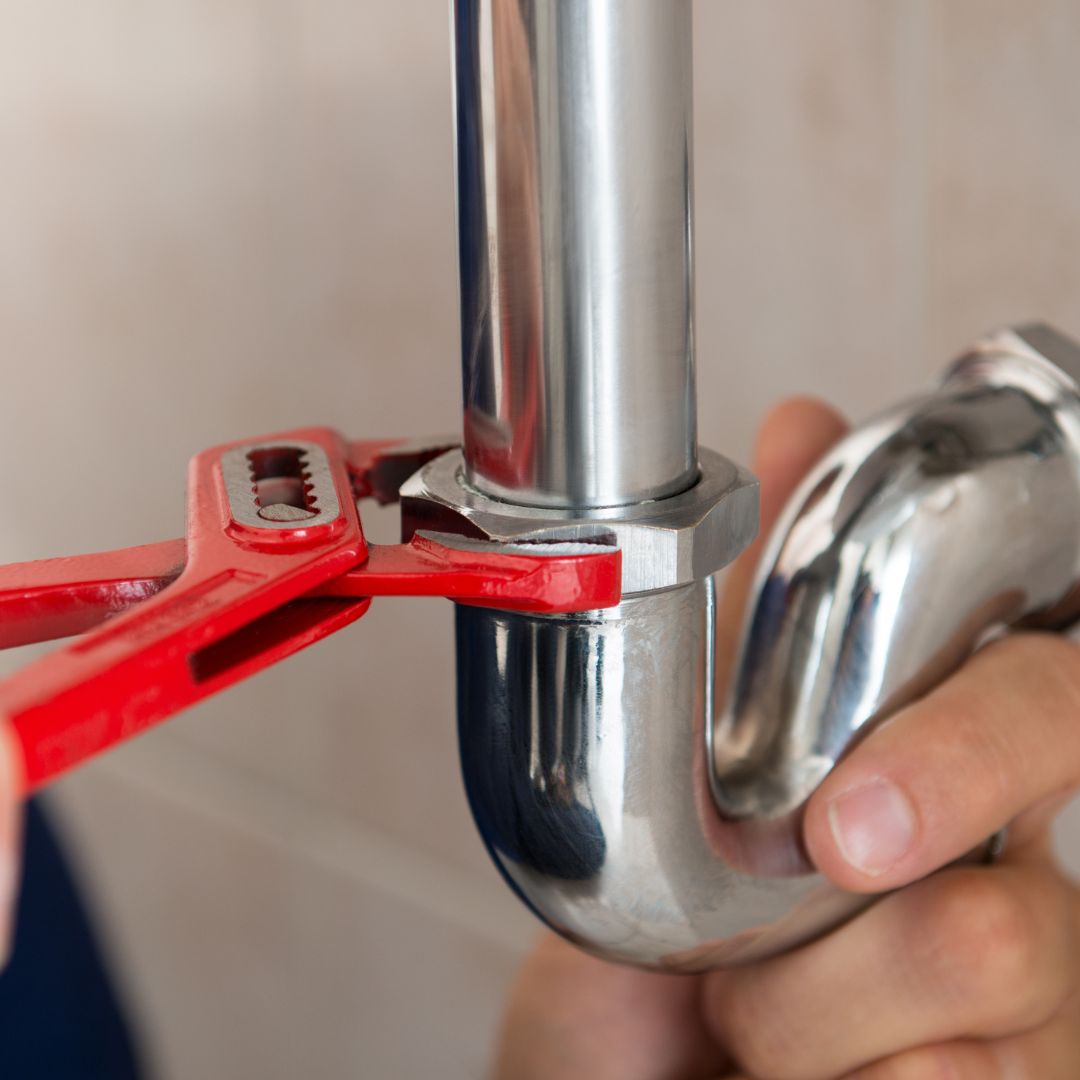 a wrench secured around a plumbing pipe
