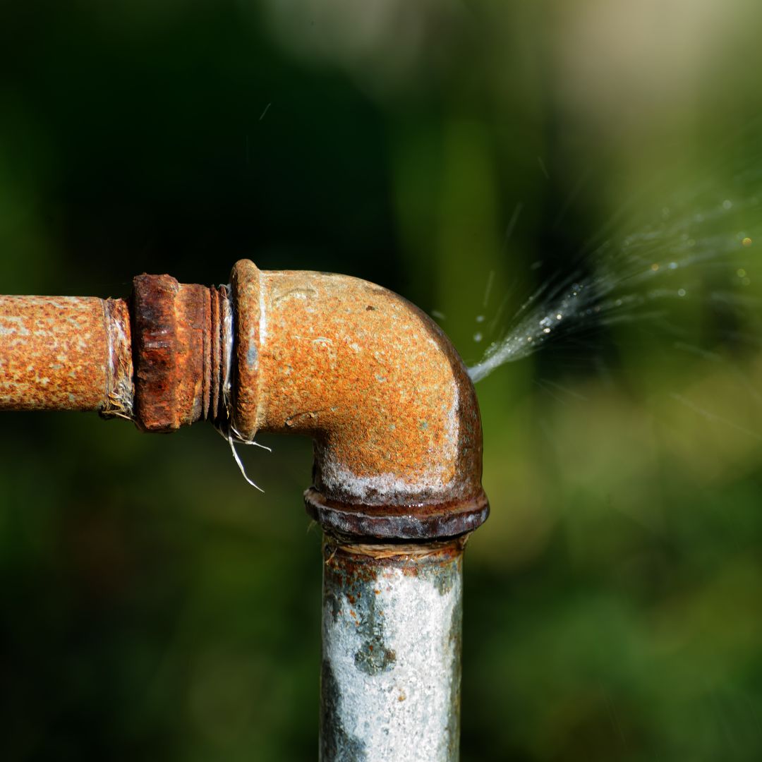rusty pipe spraying water