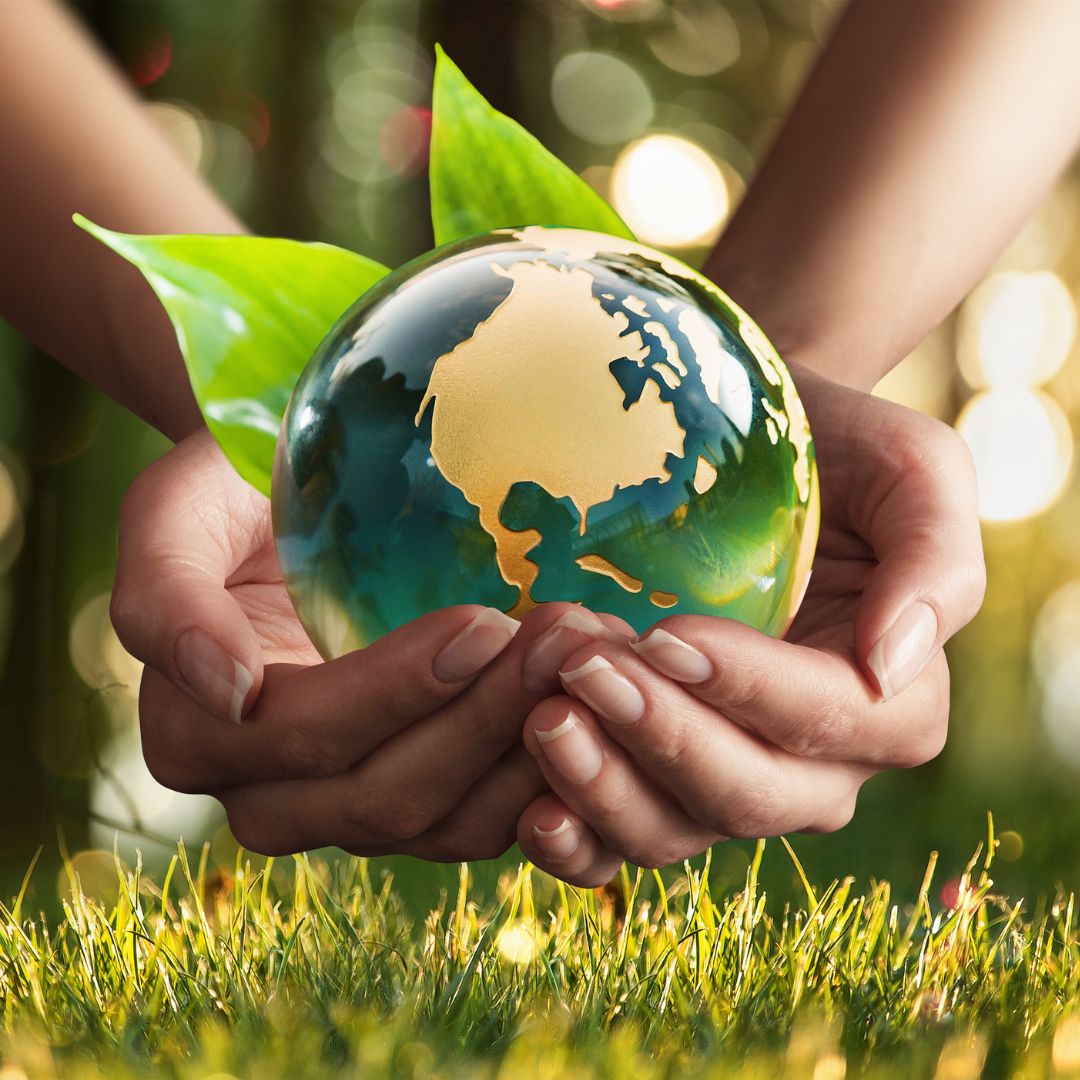 Rendered graphic of planet earth sitting on grass