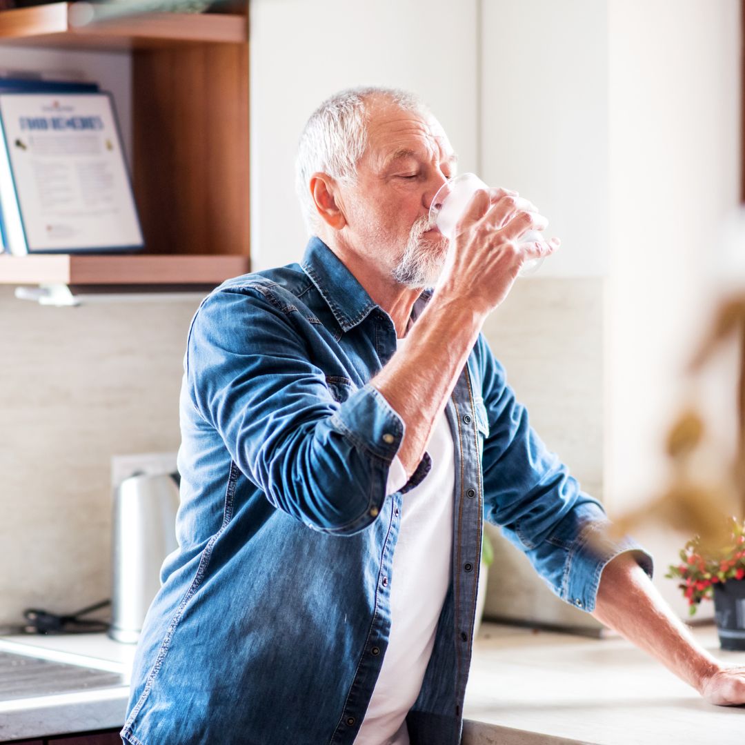 Person drinking a glass of water